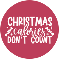 "Christmas calories don't count" - crveni krug s bijelim veselim božićnim natpisom.